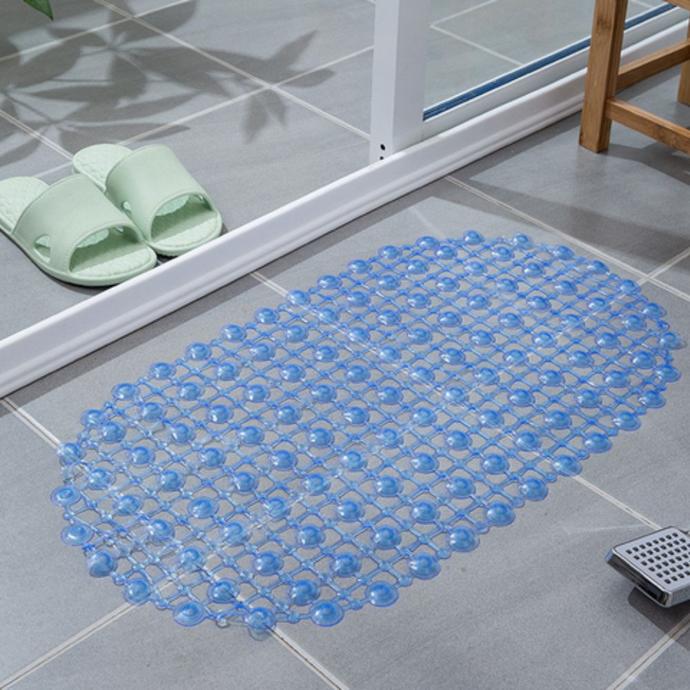 Blue bath mat on a tiled bathroom floor with green slides nearby.