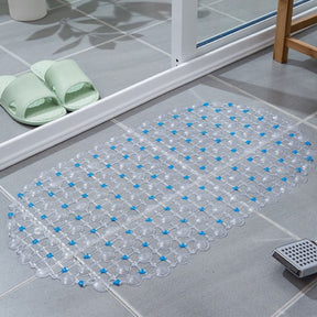 Transparent bath mat with blue dots on a bathroom floor