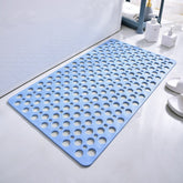 Blue bath mat with circular holes on a bathroom floor