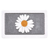 Gray bath mat with a white daisy design on a white background