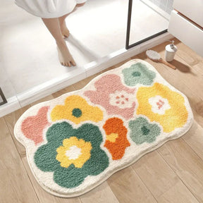 Floral patterned bath mat on a wooden floor with a bathroom setting.