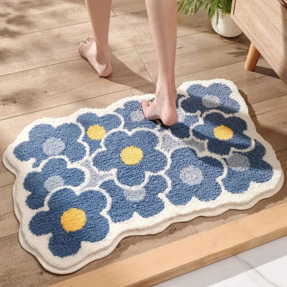 Floral-patterned rug on a wooden floor with a person stepping onto it.