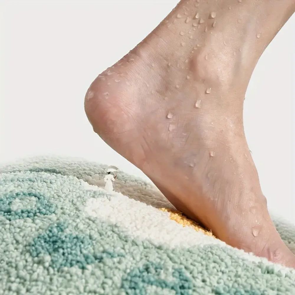 Close-up of a foot stepping onto a textured green surface