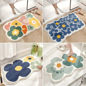 Four floral-patterned bath mats on a wooden floor.