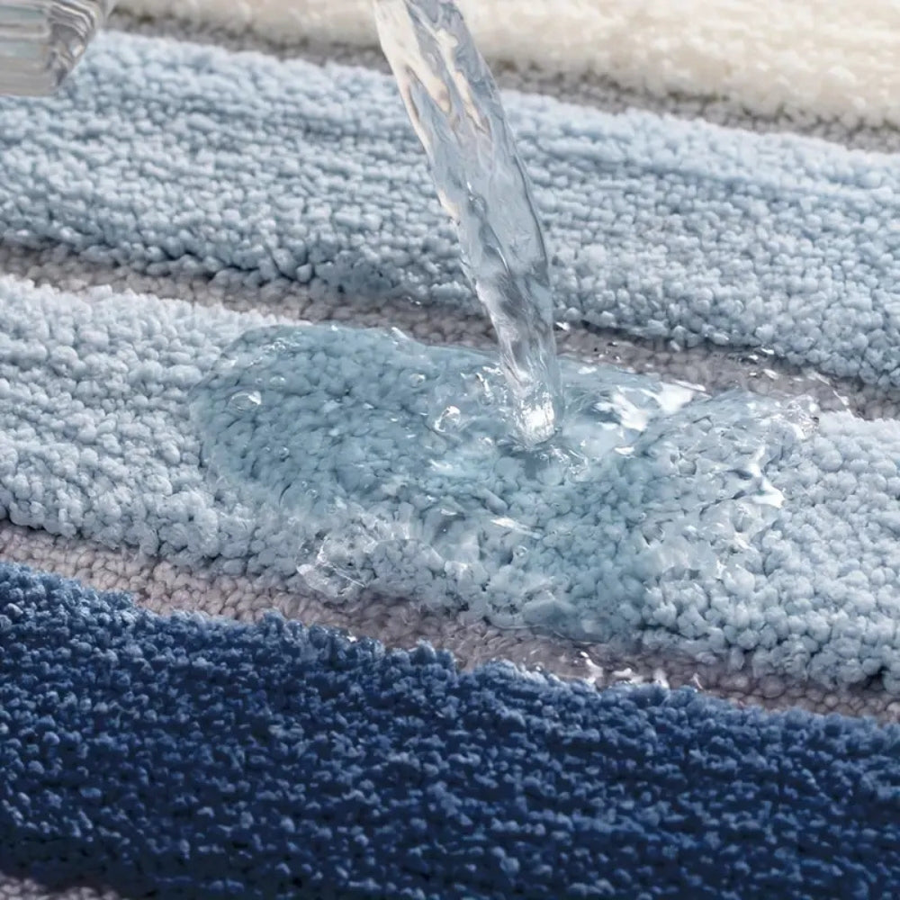 Blue textured rug with water being poured onto it