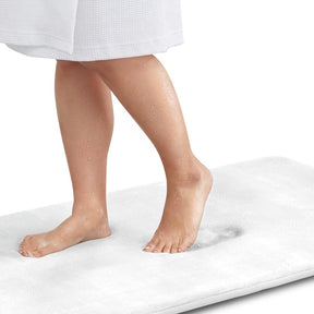 Person standing on a white mat with a white background