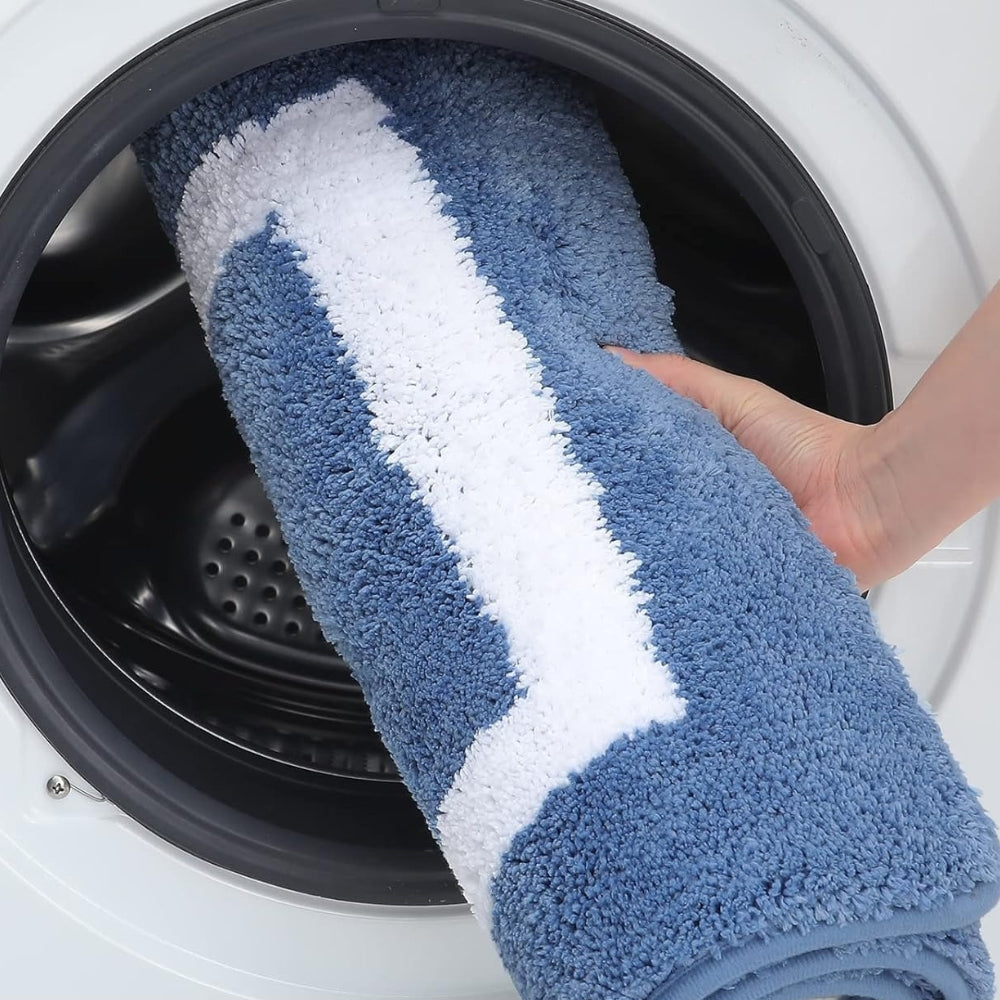 Blue and white towel being pulled out of a washing machine
