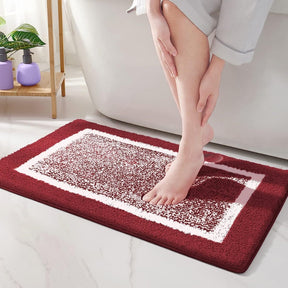 Person stepping onto a red bath mat in a bathroom setting