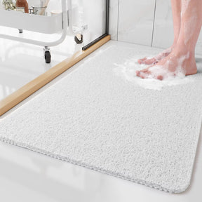 Person stepping onto a textured bath mat in a bathroom setting
