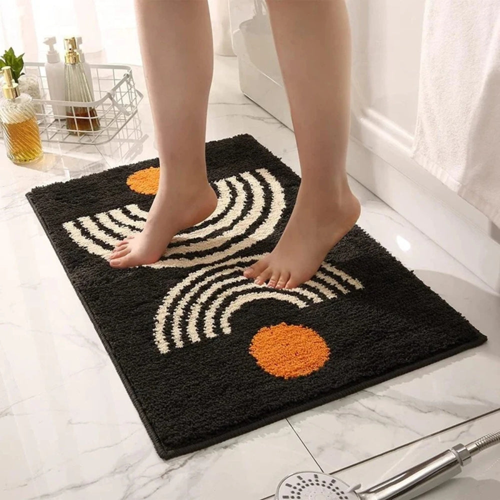 Person stepping onto a decorative bath mat with circular patterns on a bathroom floor.