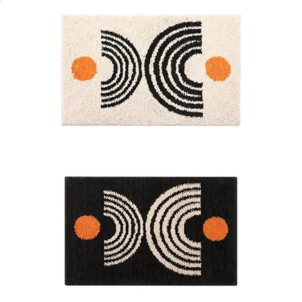 Two geometric patterned rugs with black, white, and orange design on a white background.